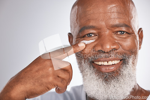 Image of Black man, beauty and face cream for skincare of senior in studio for self care with dermatology and cosmetic product. Portrait of happy male with lotion on skin for glow, health and wellness on grey