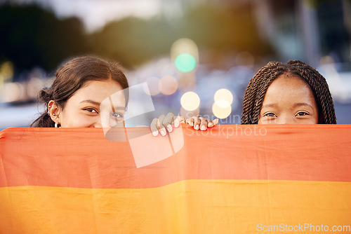 Image of Love, pride flag and portrait of a lesbian couple at a LGBTQ, freedom or community parade in the city. Happy, celebration and interracial gay women with commitment at a LGBT, rainbow sexuality event.