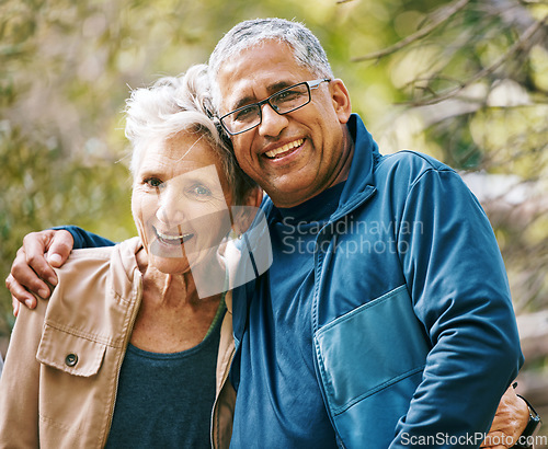 Image of Hiking, portrait and romance with a senior couple hugging in the woods or nature forest together in summer for a hike. Fun, joke and bonding with a mature man and woman enjoying retirement outdoor