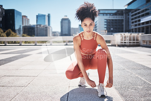 Image of Fitness, portrait and black woman tie shoes getting ready for training in city. Face, sports and female runner tying sneaker lace and preparing for workout jog, running or exercise outdoors on street