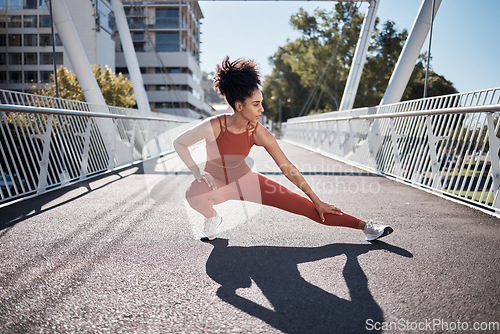 Image of Sports, stretching legs and woman on ground or city bridge exercise, running and training in sports shoes fashion. Warm up, focus and athlete or black woman workout for body, muscle and health goals