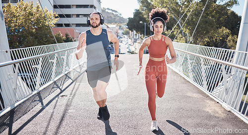 Image of Fitness, couple and running with headphones for city exercise, workout or marathon training. Young man, woman and outdoor cardio sports with music, motivation and focus for wellness, energy or action