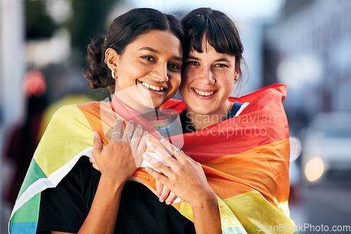 Image of Women, lgbtq and portrait with pride flag for love, equality and support in city. Gay, lesbian and couple of friends hug with rainbow identity, happy face and freedom at human rights parade event
