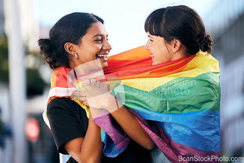 Image of Lgbtq, happy women and flag for pride, equality and protest of love, support and care in city. Gay, lesbian and couple of friends with rainbow identity, gen z festival and human rights freedom event