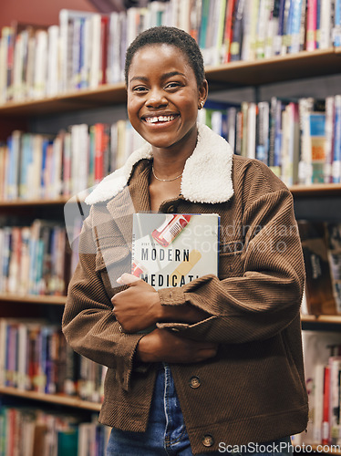 Image of Black woman student, portrait and library with book, research or medical education with smile. African gen z woman, books and shelf at university for goals, learning and motivation for future career