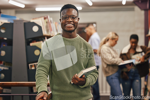 Image of Black man, book and portrait in library with smile, research and studying at college for education. African gen z student, happy and university for books, learning or vision for future career goal