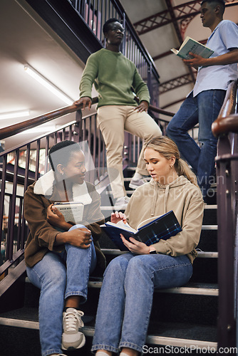 Image of College student group, stairs and reading for study, research and discussion for exam, test or education. Students team, diversity and books for success, goals and focus at university with teamwork