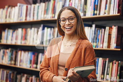 Image of Face, student and woman in university in library ready for learning. Portrait, education and happy female from Brazil standing by bookshelf with book for studying, knowledge and literature research.