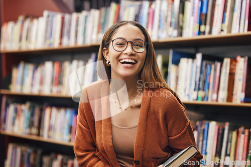 Image of Face, student and woman in library with book ready for learning. Portrait, university education and happy female from Brazil standing by bookshelf for studying, knowledge and literature research.