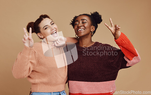 Image of Fashion, peace sign and women friends in studio with hand gesture, smile and happiness on brown background. Freedom, beauty and black woman with happy girl for relaxing, cosmetics and emoji together