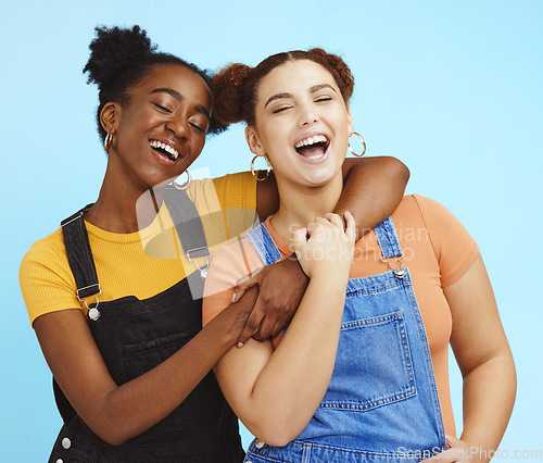 Image of Happy young women, lesbian and couple with fashion, marketing and lgbt pride, love and fun against blue background. Lgbtq community, gen z youth laughing together and freedom with style and pride