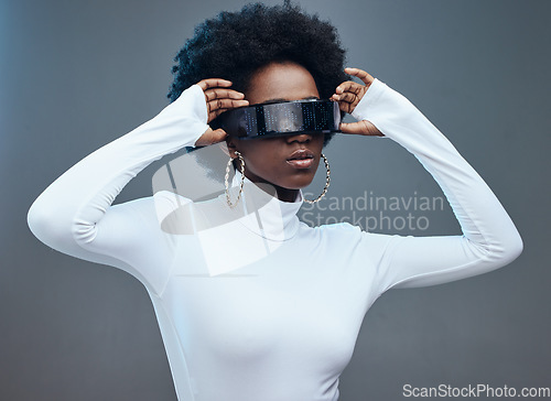 Image of Fashion, hands and black woman with futuristic sunglasses, gen z and stylish with trendy designer brand against studio background. Young, cyberpunk and natural curly hair with beauty and edgy style