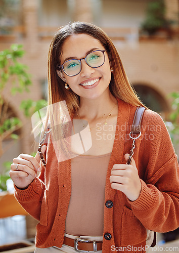 Image of Student, woman with smile in portrait, university and education, scholarship and outdoor with learning and study. College student, academic growth and happy with glasses and geek on campus