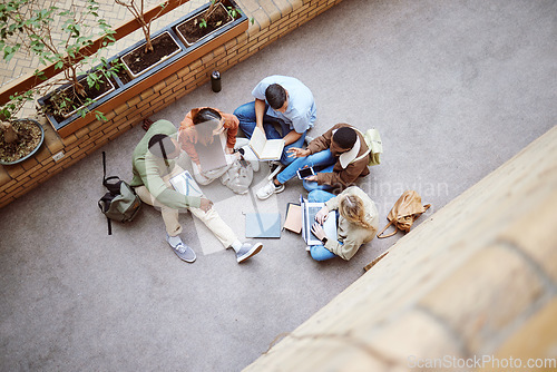 Image of University, group collaboration and students working on research, college project or education study. Knowledge learning, teamwork meeting and top view of diversity people coworking on school floor