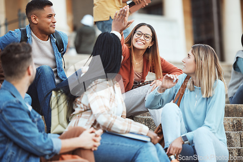 Image of Talking, students or high five on university stairs, college campus bleachers or school steps for education diversity success. Smile, happy friends or partnership gesture in learning goals or target