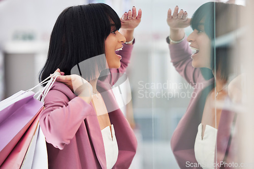 Image of Excited woman, window shopping and mall for retail therapy, sale or customer discount at a store. Paper bag, fashion and female happy about clothes, promotion or commerce product during travel