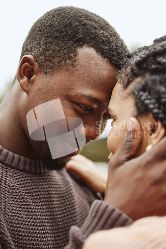 Image of Black couple, forehead and smile for love, embrace or happy relationship bonding together in the outdoors. Black man touching heads and holding woman in romance, support or hug for partnership