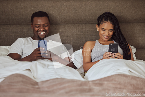 Image of Black couple, smartphone and happiness together in bed for social media streaming, relax quality time or reading online. African man smile, black woman and happy watching video on phone in bedroom