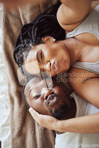 Image of Black couple, love and bedroom selfie while happy and funny together, pouting on bed at home, apartment or hotel. Portrait of a young man and woman in a happy marriage with commitment in top view