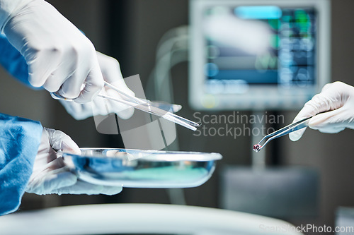 Image of Doctors hands, surgery team and tools in icu, hospital or healthcare with tweezers, bullet or metal. Surgeon, health and emergency theater with scissor, bowl or ppe for safety, medical work or clinic