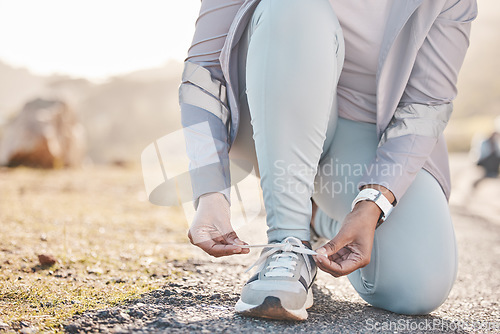 Image of Woman, hands and shoelace for mountain runner, outdoor workout and fitness in summer in countryside. Running adventure, sneakers and tie lace for safety, speed and balance in road training for health