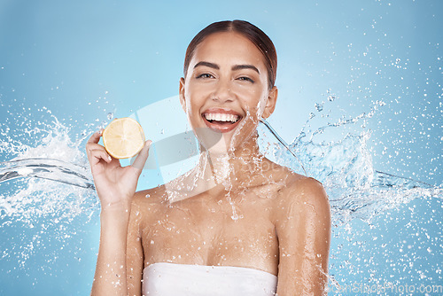 Image of Lemon, skincare and woman in water splash for beauty, cosmetics and cleaning advertising of vegan product in studio mockup. Happy model portrait, fruit in hand and healthy glow or dermatology shine