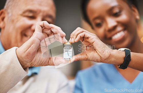 Image of Corona virus vaccine, heart hands and people with vial in nursing home in support of medical innovation, medicine product or bottle. Covid 19 vaccination, healthcare and finger shape of patient trust