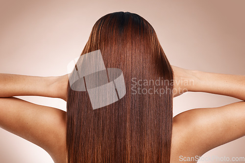 Image of Hair, beauty and back of woman in studio for hair care, hair products and cosmetics on beige background. Salon, balayage and girl touch healthy, shine and long hair for hair salon, treatment and glow