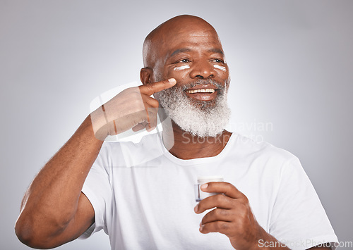 Image of Black man, beauty and skincare with facial cream on skin with dermatology and cosmetics for healthy glow. Face of senior male with sunscreen or lotion container on grey studio background for wellness