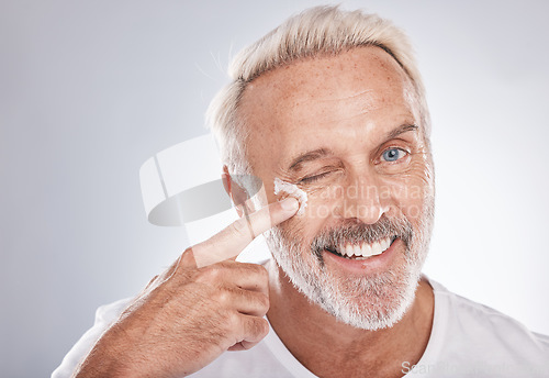 Image of Skincare, beauty and face cream of senior man on white background for spa, wellness and dermatology. Cosmetics, grooming and elderly male with anti aging beauty products, facial treatment and lotion