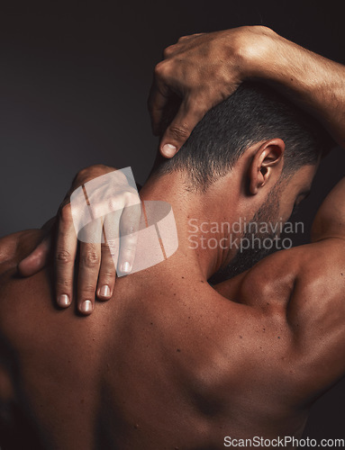 Image of Stretching, fit man and back muscle on dark black studio background. Self love, self care and model embracing skin, confidence and body positivity with an artistic body hug and creative expression