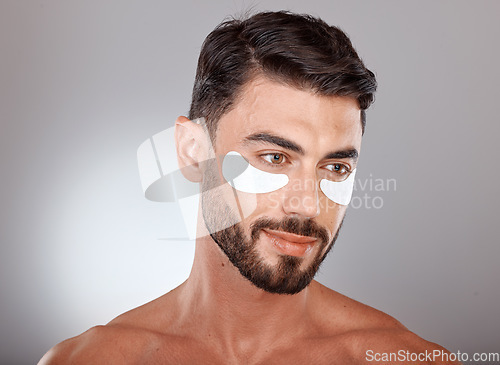 Image of Skincare, beauty and man with mask for eyes on gray background for wellness, facial treatment and dermatology. Grooming, luxury spa and male with face patch, eye pads and cosmetics products in studio