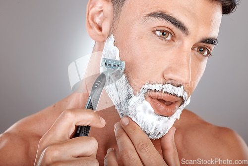 Image of Grooming, foam and shaving with face of man with razor for beauty, hygiene and skincare with morning routine. Self care, facial and shave beard with model and cream product for wellness and cleaning