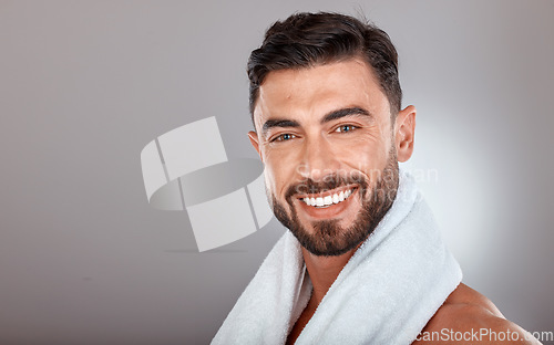 Image of Man with towel, beauty and face with skincare, hygiene and self care portrait against studio background. Grooming, skin and glow with cosmetic mockup, facial wellness and clean teeth with smile