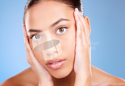 Image of Portrait, skincare or model in studio after beauty or facial grooming routine on a blue background with mockup space. Luxury, healthy girl or beautiful woman touching face for self love or self care