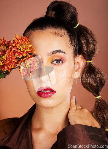 Image of Makeup, beauty or woman in studio with flowers for art fashion and natural facial cosmetics for self care. Face portrait, orange plants or girl model with red lipstick, eyeshadow and glowing skin