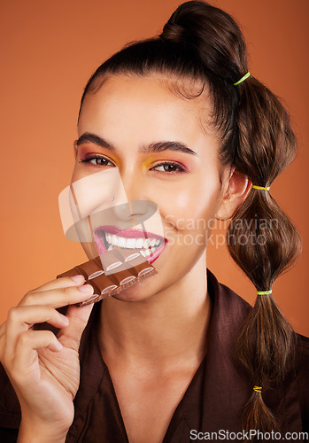 Image of Chocolate, beauty and portrait girl eating sugar candy, sweets or dark chocolate dessert for stress relief. Skincare, facial cosmetics makeup and model woman face with cacao product for antioxidants