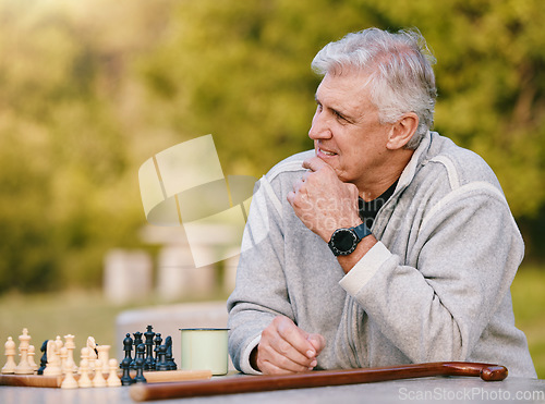 Image of Senior man, park and thinking for chess, game and competition at table by trees, sunshine and focus. Elderly board game, outdoor and strategy for contest in nature, relax and play in Los Angeles