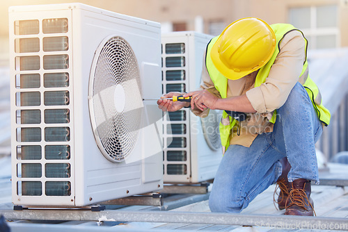 Image of Air conditioning, technician or engineer on roof for maintenance, building or construction of fan hvac repair. Air conditioner, handyman or worker with tools working on a city development project job
