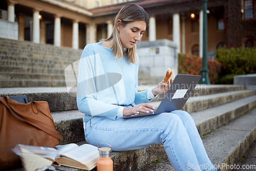 Image of College, learning and food with woman and laptop for education, lunch break and academy research. University, knowledge and goal with girl student and sandwich on stairs of campus for relax and study