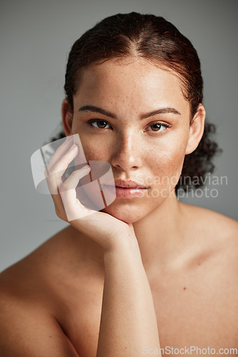 Image of Black woman, skincare and natural face for beauty cosmetic and glow treatment campaign portrait. Healthy body care of model with beautiful freckles on hydrated skin in gray studio background.