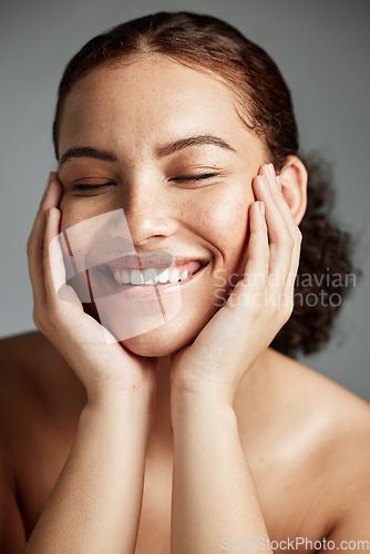 Image of Face, skincare and makeup with a model black woman in studio on a gray background to promote natural care. Facial, wellness and makeup with an attractive young female happy with her cosmetic product