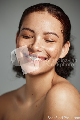 Image of Face, beauty and skincare with a model black woman in studio on a gray background to promote natural care. Facial, wellness and makeup with an attractive young female happy with her skin product