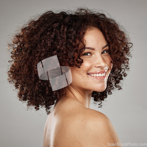 Image of Portrait, face and skin with a model black woman in studio on a gray background for beauty treatment. Facial, wellness and natural with an attractive young female posing to promote a skincare product