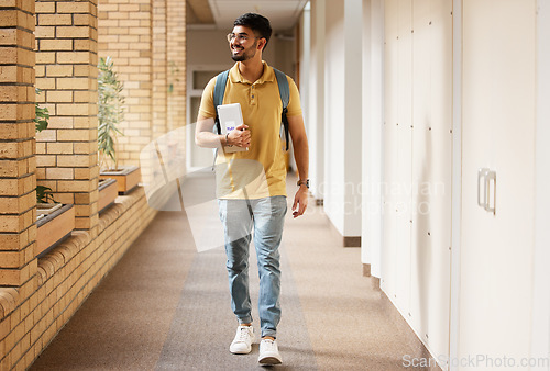 Image of University student, college and indian man walking with a smile and backpack down campus corridor. Gen z male happy about education, learning and future after studying with scholarship at school