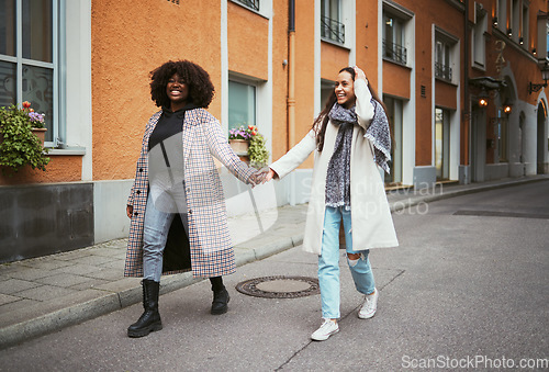 Image of Fashion, holding hands and lesbian couple walking in street enjoying holiday, vacation and adventure on weekend. Love, lgbtq relationship and women together for happy lifestyle, freedom and relaxing