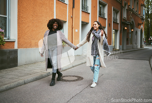 Image of Love, holding hands and lesbian couple walking in street enjoying holiday, vacation and adventure. Fashion, lgbtq relationship and women together for happy interracial marriage, freedom and relaxing