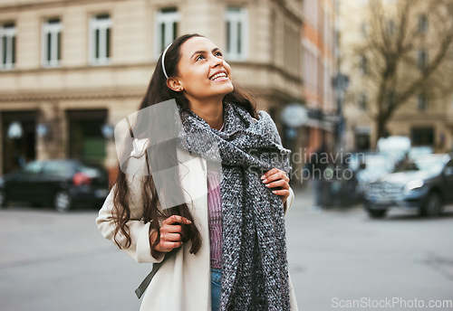 Image of Walking, city buildings and happy woman on outdoor travel adventure in sidewalk street, road or journey In Chicago Illinois. Urban architecture, beauty and girl smile on winter vacation tour in USA