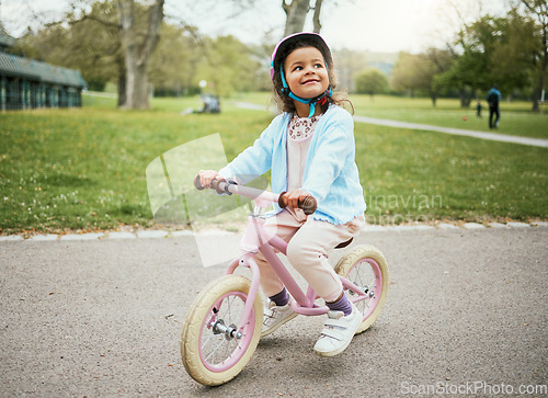 Image of Cycling, thinking and child on a bike in the park, outdoor activity and learning in New Zealand. Sport, happiness and girl kid playing on bicycle ride in the neighborhood street or road in childhood