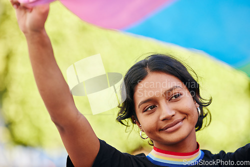 Image of Rainbow, flag and gay pride with an indian woman in celebration of lgbt equality, inclusion or freedom. Community, support or human rights with a gender neutral or non binary female celebrating lgbtq